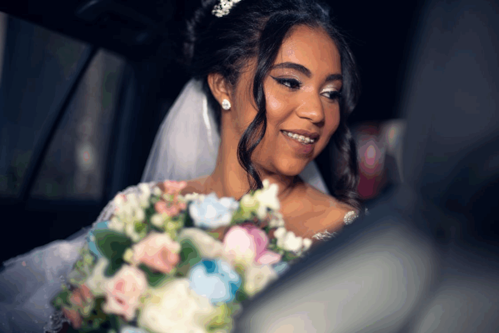 A bride smiles in a car.
