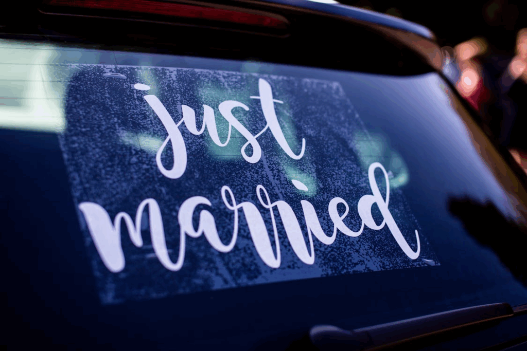 A just-married sticker temporarily placed on a car.