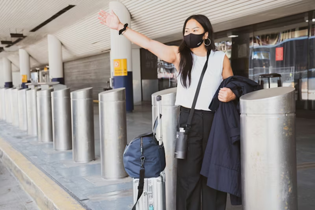 A woman signals to her transfer after arriving.
