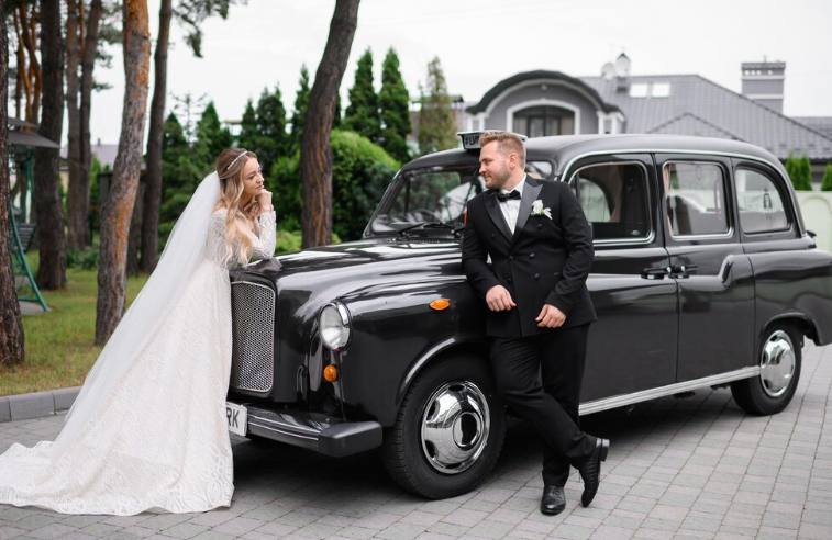 A couple standing in front of a car