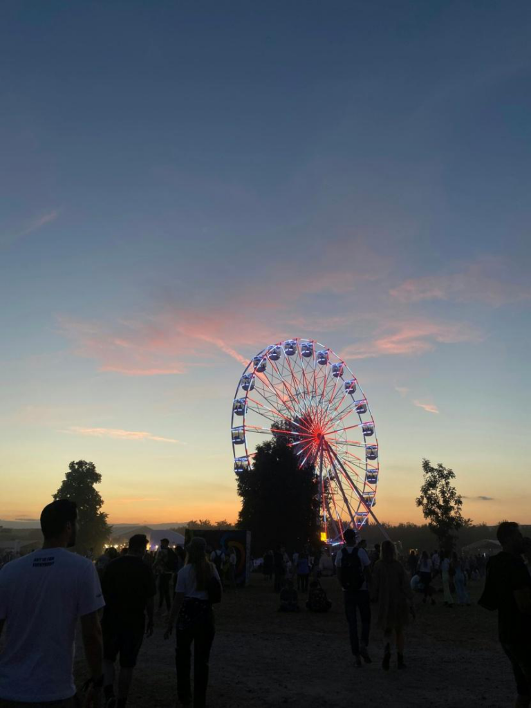 A group of people around a Ferris wheel at Coachella