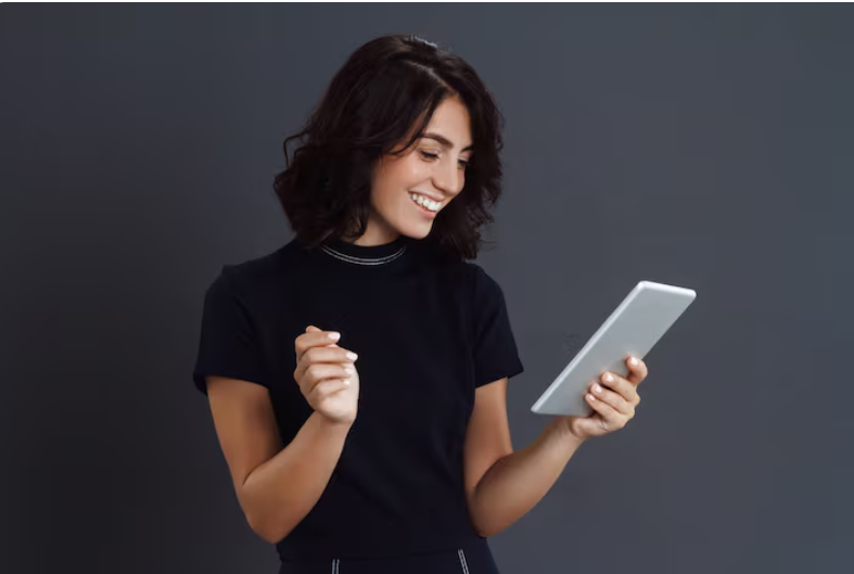 Woman using a tablet to book a car service online for transportation