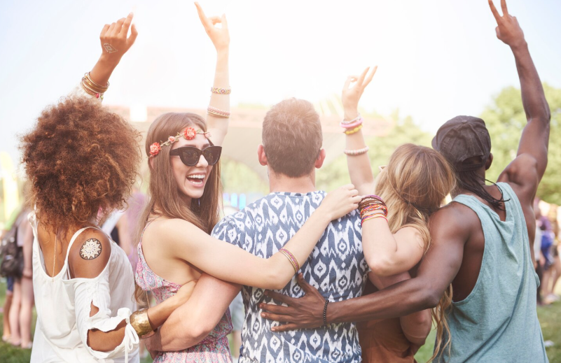 Young cheerful people having fun together at a music festival