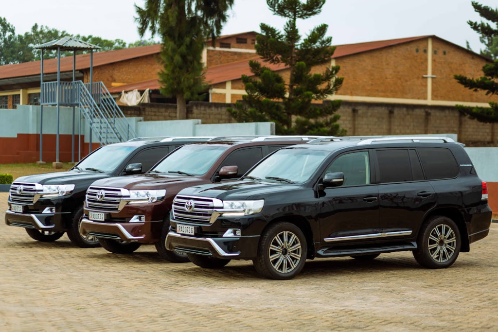 Row of black cars parked together representing a fleet of luxury transportation vehicles