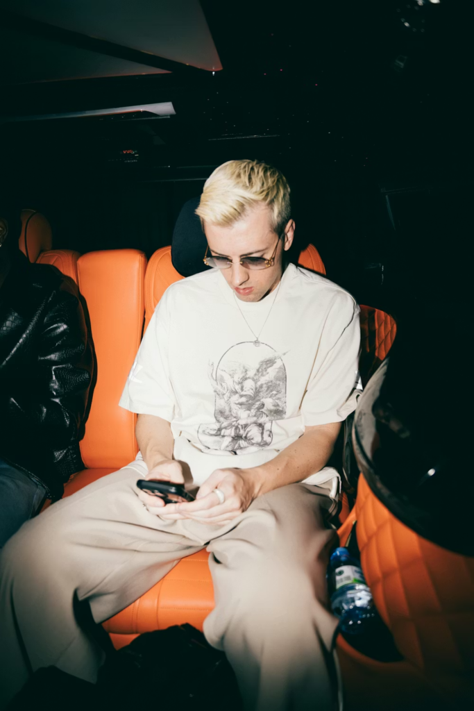 A man using his phone while sitting in an SUV