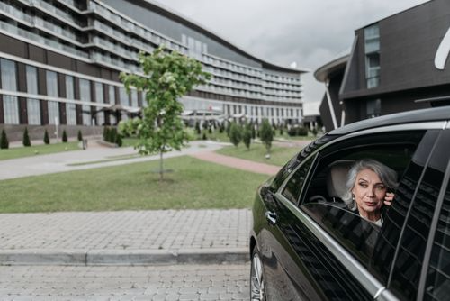 Businesswoman sitting comfortably inside a private airport vehicle